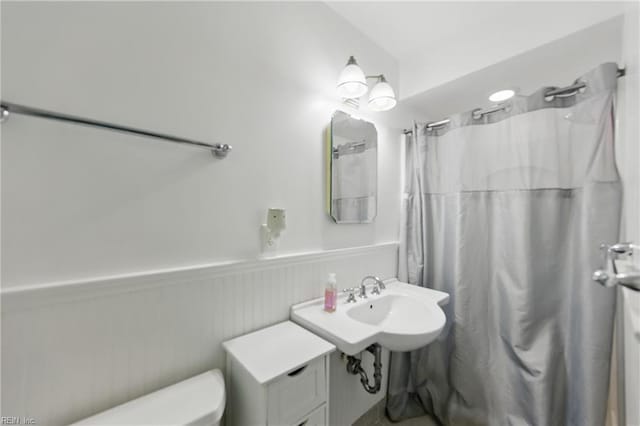 1601 Upton Pl, Suffolk, VA 23433 - bathroom featuring wainscoting, curtained shower, and toilet