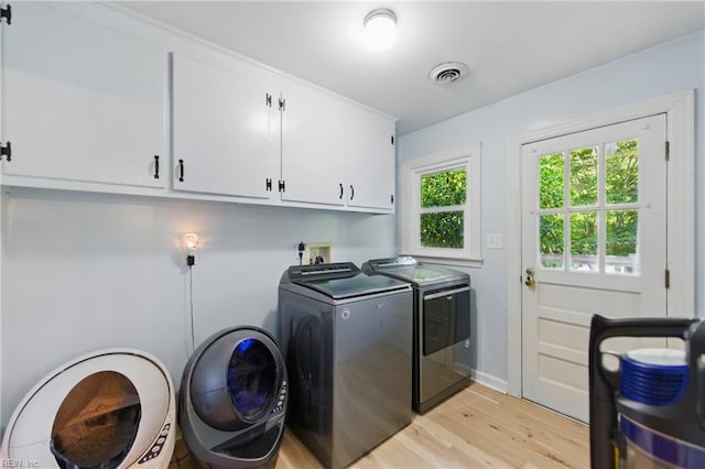 1601 Upton Pl, Suffolk, VA 23433 - clothes washing area featuring cabinet space, light wood-style floors, separate washer and dryer, and visible vents