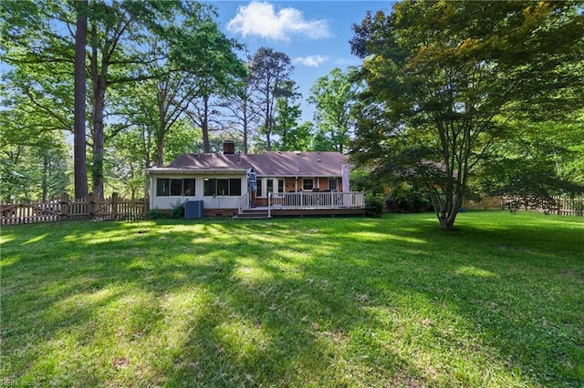 1601 Upton Pl, Suffolk, VA 23433 - back of house featuring a chimney, a lawn, fence, a wooden deck, and central air condition unit