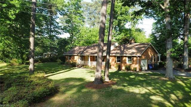 1601 Upton Pl, Suffolk, VA 23433 - view of front of home with covered porch, a garage, a chimney, and a front lawn