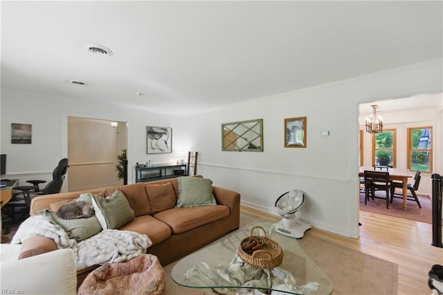 1601 Upton Pl, Suffolk, VA 23433 - living room with crown molding, a notable chandelier, visible vents, and light wood-style floors