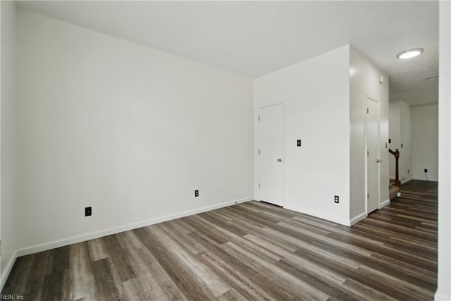 unfurnished room featuring wood finished floors and baseboards