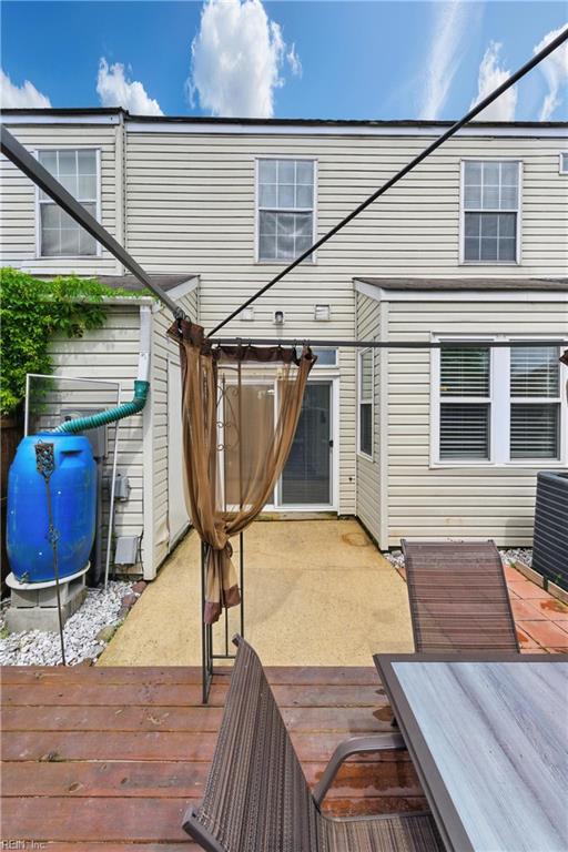 wooden terrace featuring cooling unit and fence