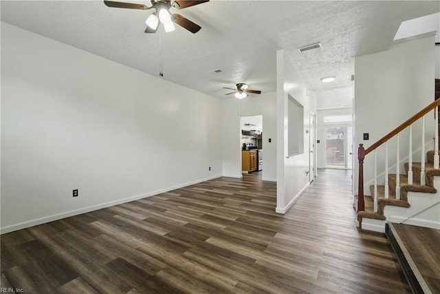 interior space with stairway, visible vents, ceiling fan, and dark wood-type flooring