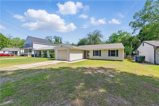view of front of home featuring concrete driveway, a front lawn, and a garage