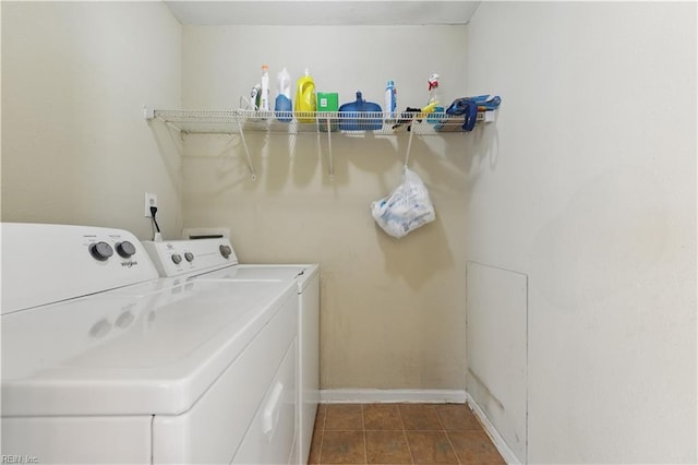 laundry room featuring separate washer and dryer, laundry area, and baseboards