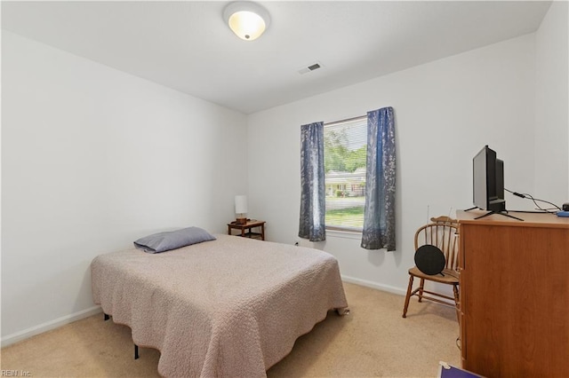 bedroom featuring light carpet, baseboards, and visible vents