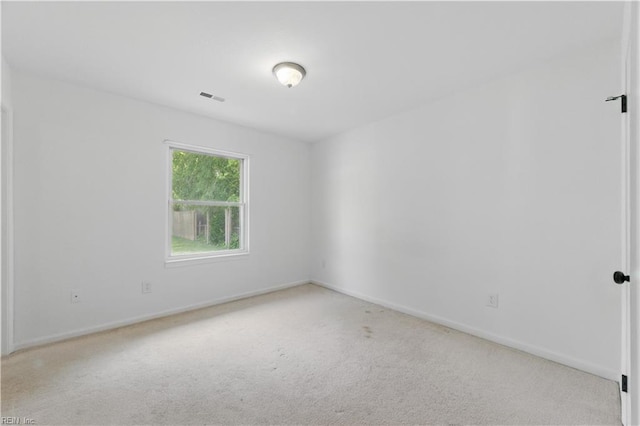 spare room with baseboards, visible vents, and carpet floors