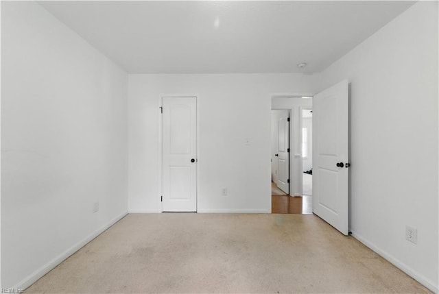 unfurnished bedroom with carpet flooring and baseboards
