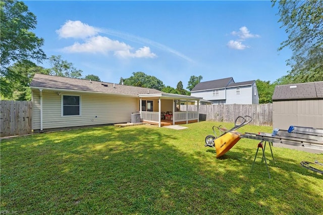 back of property featuring a lawn and a fenced backyard