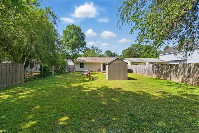 view of yard with a fenced backyard, an outdoor structure, and a shed