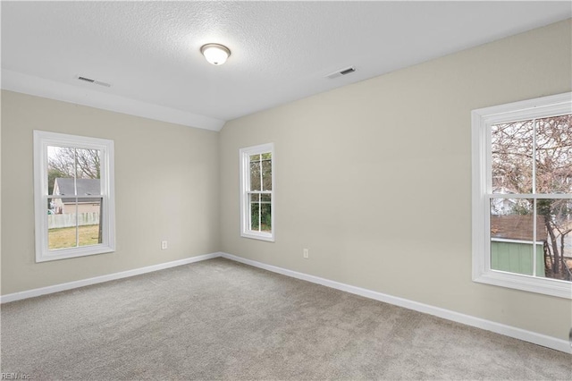 unfurnished room with carpet floors, baseboards, and visible vents