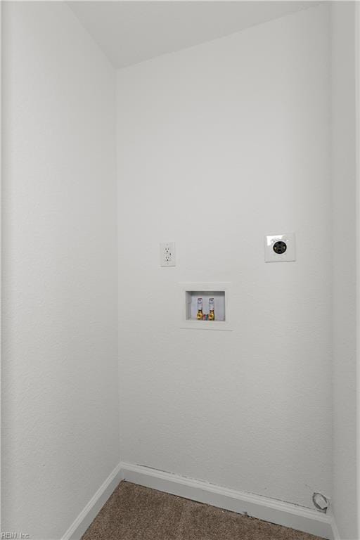 washroom featuring electric dryer hookup, laundry area, dark carpet, hookup for a washing machine, and baseboards