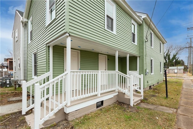 view of front of property with covered porch and crawl space