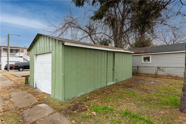 view of outbuilding with an outdoor structure and fence