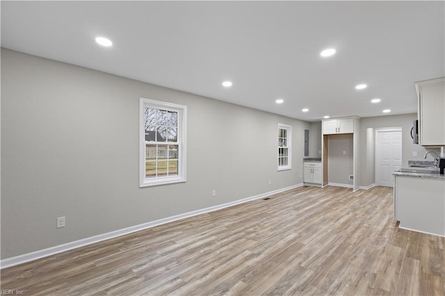 interior space with light wood finished floors and recessed lighting