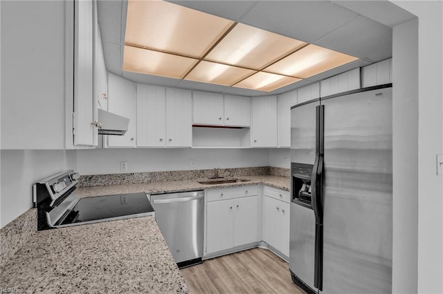 kitchen with stainless steel appliances, a sink, white cabinetry, range hood, and open shelves