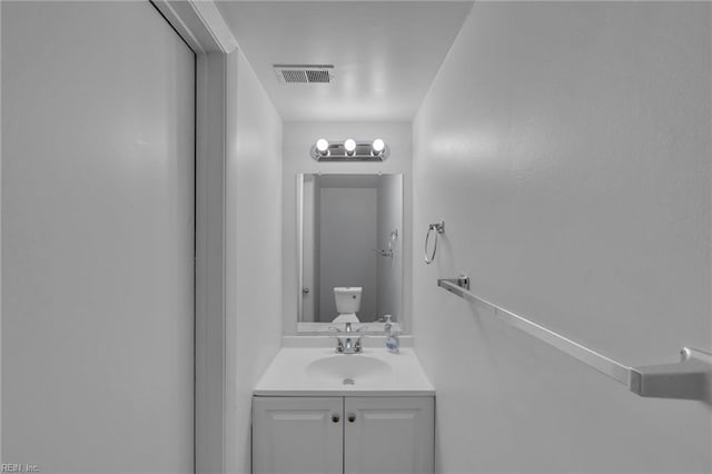 bathroom featuring toilet and vanity