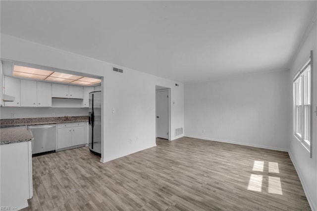 unfurnished living room with light wood finished floors and baseboards