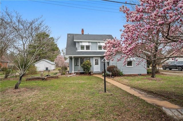 view of front of home featuring a front yard, a chimney, and roof with shingles
