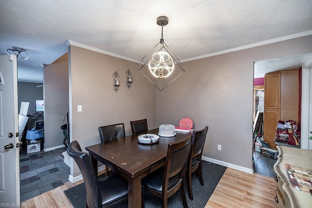 dining room with baseboards, a notable chandelier, a textured ceiling, and light wood-style floors
