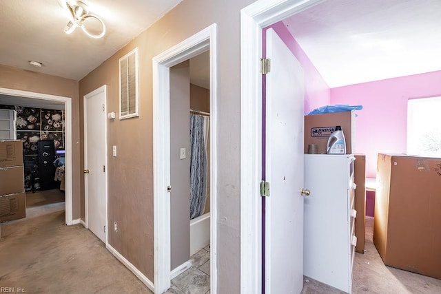 hall featuring carpet flooring and visible vents