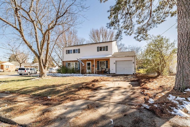 colonial house featuring a porch, brick siding, a garage, and aphalt driveway