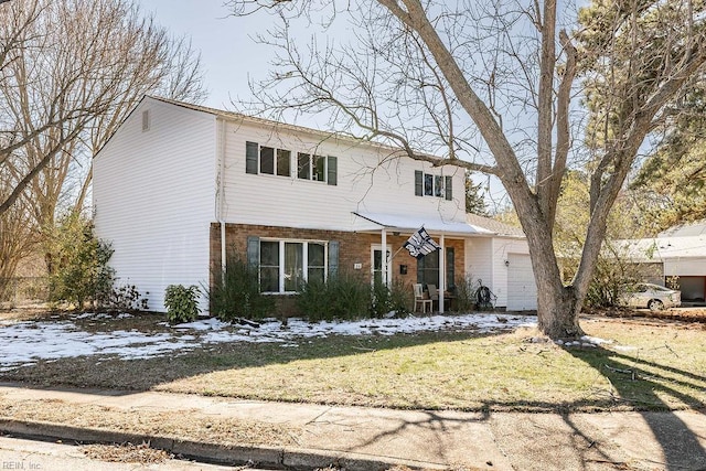 traditional-style home featuring an attached garage and brick siding