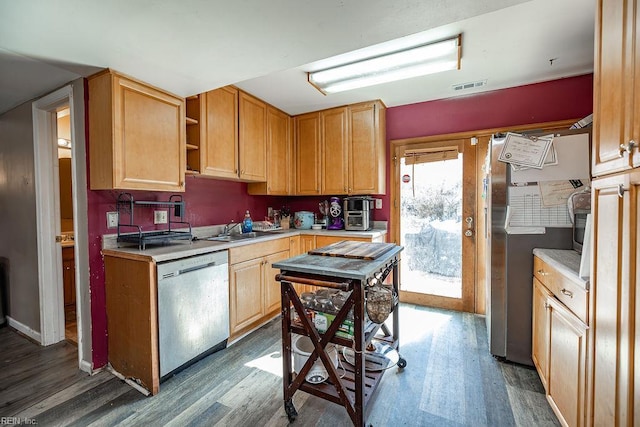 kitchen with dark wood-style flooring, stainless steel appliances, and visible vents