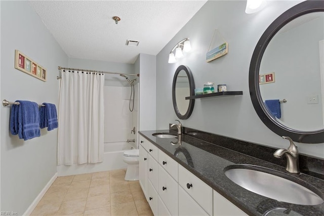 bathroom featuring a textured ceiling, shower / tub combo, visible vents, and a sink