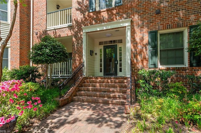 doorway to property with brick siding