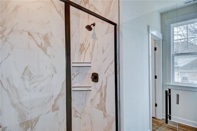 full bath featuring a marble finish shower and visible vents