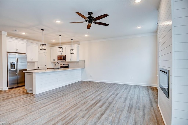 kitchen with light wood-style floors, ceiling fan, light countertops, appliances with stainless steel finishes, and recessed lighting