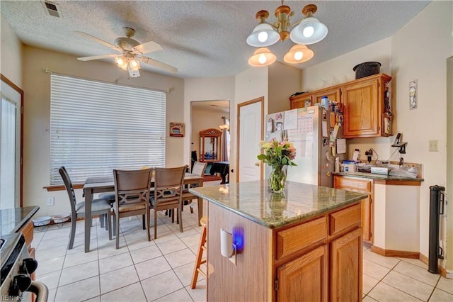 507 Landmark Ct, Chesapeake, VA 23322 - kitchen with freestanding refrigerator, light tile patterned floors, a ceiling fan, stone countertops, and range