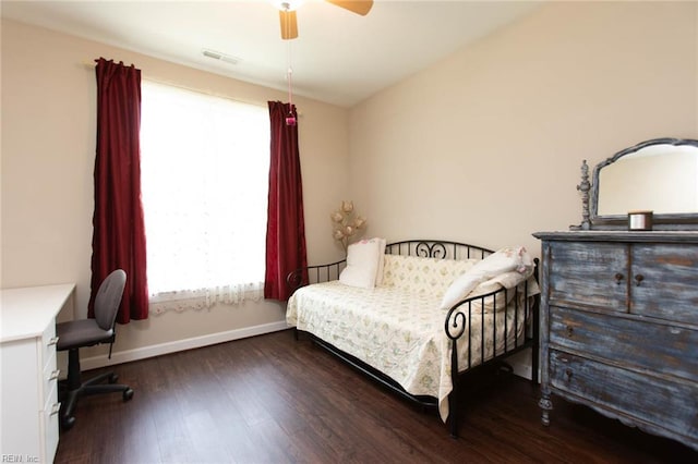 bedroom with visible vents, wood finished floors, baseboards, and ceiling fan