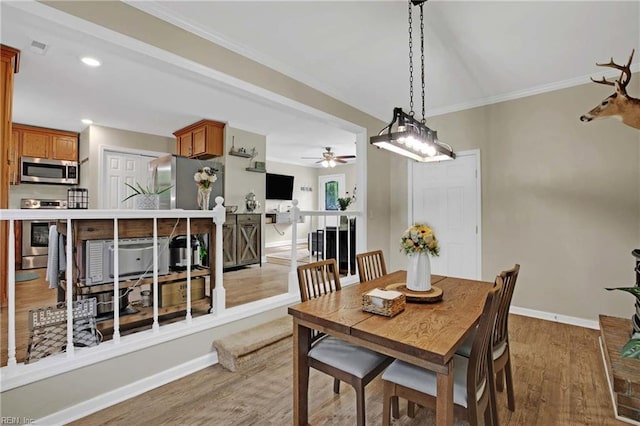 dining area featuring wood finished floors, ceiling fan, baseboards, ornamental molding, and recessed lighting