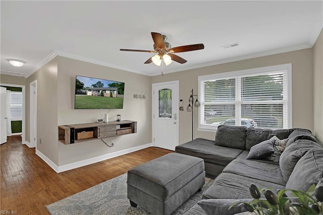 living area featuring ceiling fan, wood finished floors, crown molding, and baseboards