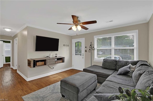 living room with ceiling fan, wood finished floors, crown molding, and baseboards