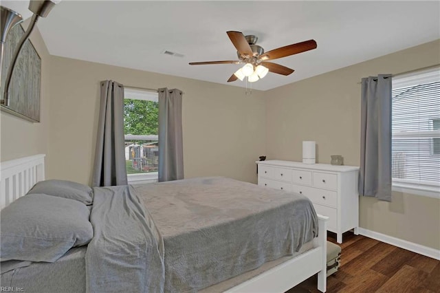 bedroom featuring dark wood-style flooring, baseboards, and ceiling fan