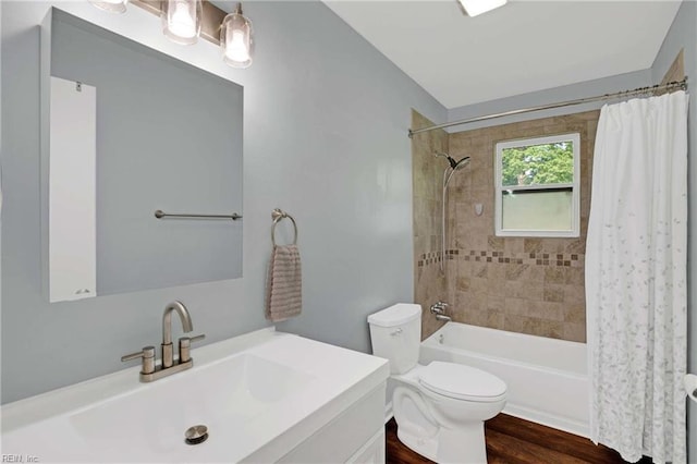 bathroom with shower / tub combo, toilet, vanity, and wood finished floors