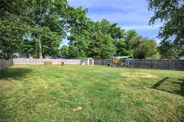 view of yard featuring a storage shed and an outbuilding