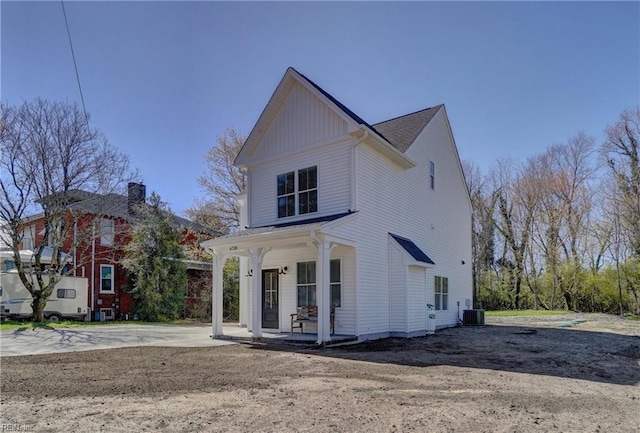 view of front of house with a porch and central AC