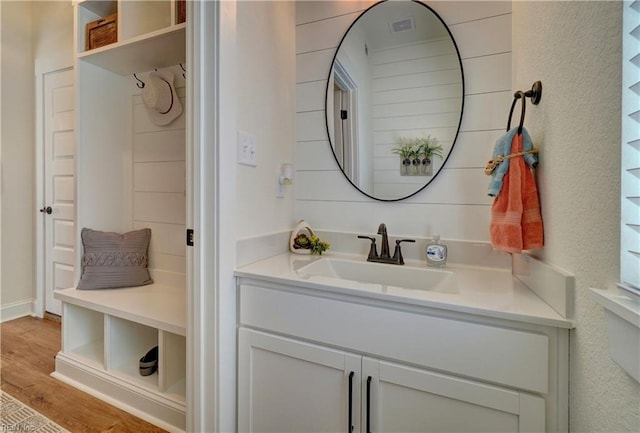 bathroom with vanity, visible vents, and wood finished floors