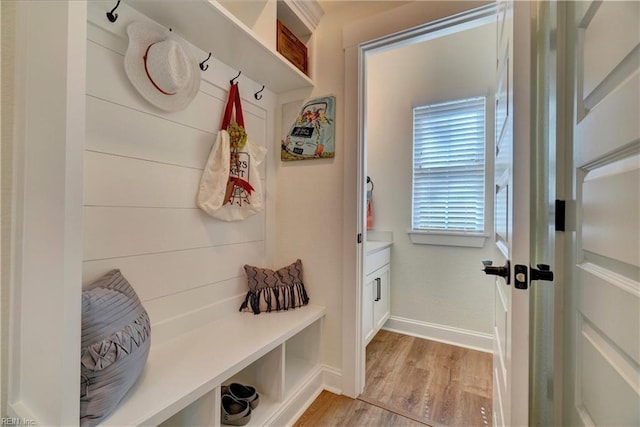 mudroom with light wood-style flooring and baseboards