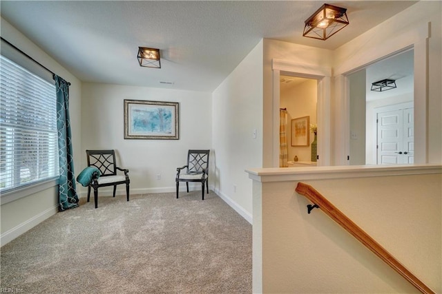living area featuring carpet floors and baseboards
