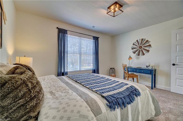 carpeted bedroom featuring visible vents and baseboards