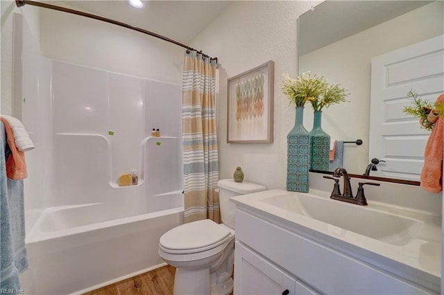 bathroom with toilet, wood finished floors, shower / bath combo, vanity, and recessed lighting