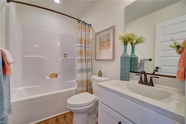 bathroom with toilet, vanity, shower / bath combo with shower curtain, and wood finished floors