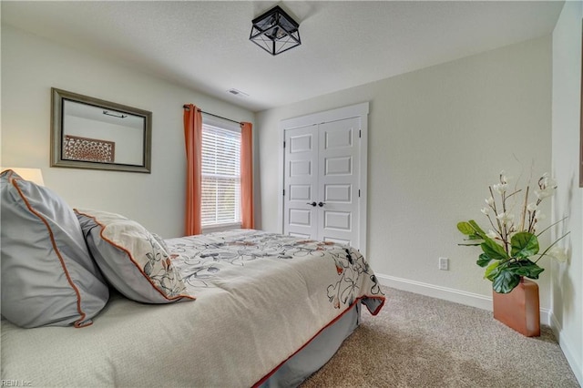 carpeted bedroom featuring visible vents and baseboards
