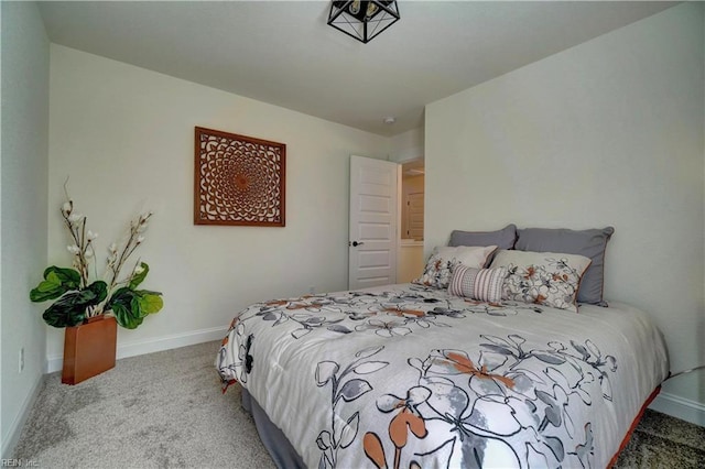 bedroom featuring carpet and baseboards